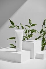 Minimalist White Catwalks Showcasing Cosmetic Product Amidst Green Foliage