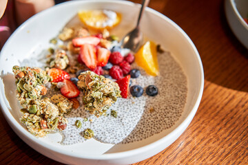 A mixture of strawberries, blueberries, and granola on a plate