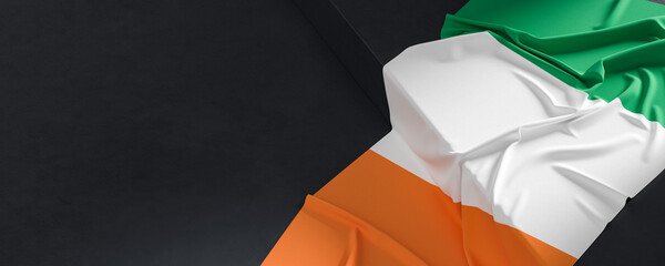Flag of Ireland. Fabric textured Ireland flag isolated on dark background. 3D illustration