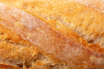 Ruddy crust of bread as an abstract background. Texture