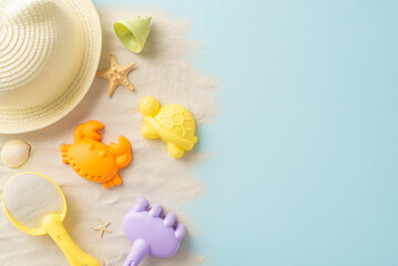Summer getaway for kids. Flat lay top view of sand play essentials: bucket, rake, sea creature...