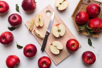 Fresh red apples with green leaves on table. cutting board with knife. Top view