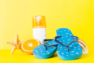 Top view composition of flip flops placed with beach accessories perspective view on table...