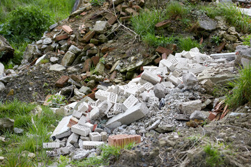 a large pile of building rubble with remains of stones and asphalt