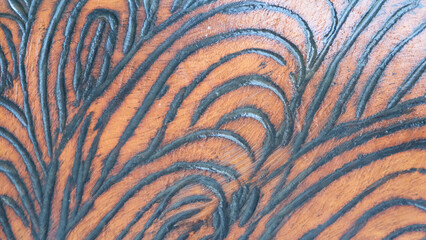 A carved wood by Australians,  adorned with intricate symbols, carrying ancient stories and wisdom of the land, connecting past and present. Wood use to fetch water.