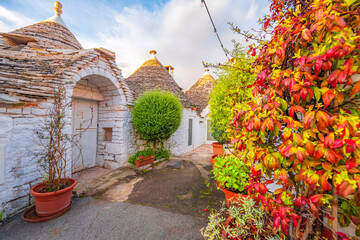 Trulli of Alberobello, Puglia, Italy. town of Alberobello with trulli houses among green plants and...