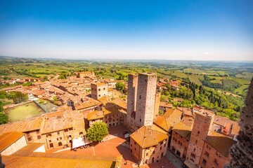 Naklejka premium Medieval San Gimignano hill town with skyline of medieval towers, including the stone Torre Grossa. Province of Siena, Tuscany, Italy.