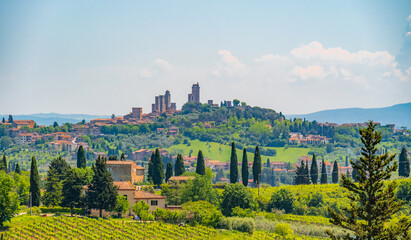 Medieval San Gimignano hill town with skyline of medieval towers, including the stone Torre Grossa....