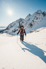 Mountaineer backcountry ski walking ski alpinist in the mountains. Ski touring in alpine landscape with snowy trees. Adventure winter sport. High tatras, Slovakia