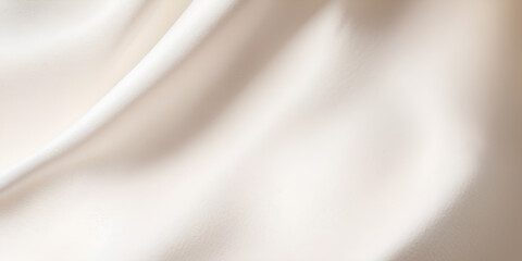 Fototapeta premium A white fabric with a pattern of waves. The fabric is smooth and silky. The waves are gentle and flowing, giving the fabric a sense of calmness and serenity