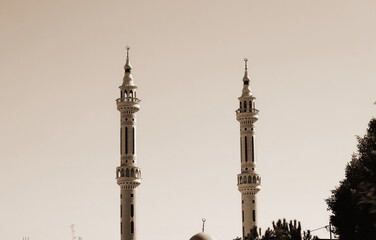Sepia Tone Twin Minarets Mosque Silhouette Against Sky