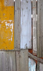 Weathered Wooden Fence Panels In Yellow And Blue