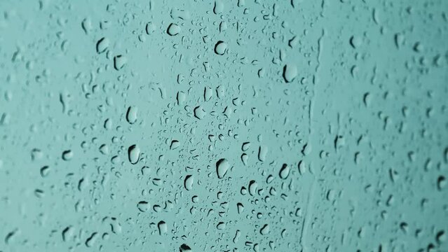Water drops hitting the glass on a rainy day