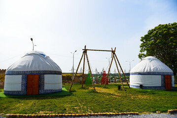 Traditional kazakh swing and white yurts