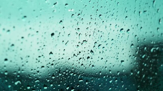 Water drops hitting the glass on a rainy day