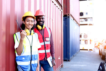 Portrait of two happy smiling industrial African engineer worker man and woman wearing safety vest...