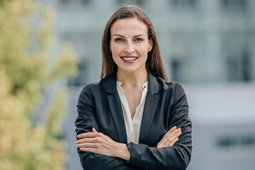 portrait of smiling businesswoman outdoors