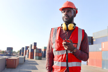 Portrait of African young engineer worker man wearing safety red vest and helmet, working at...
