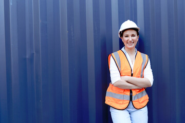 Portrait of happy smiling young beautiful woman engineer boss with blonde hair wearing safety vest...