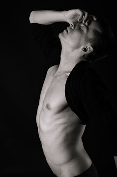 A young attractive man with a beautiful body posing in the studio.