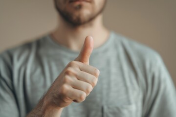 A man showing approval with a thumbs up gesture. Suitable for business and success concepts