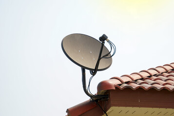 Satellite dish installed on the roof of the house for receiving television waves. Soft and...