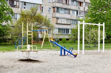 Colorful playground on yard with no children. Play yard with swing and other playground elements....