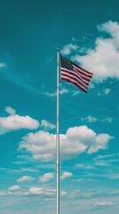 USA flag on a flagpole against a blue sky