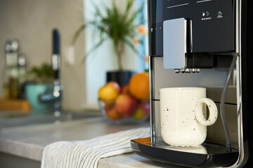 Fresh espresso at morning. Coffee machine in kitchen, close up. Modern coffee maker with freshly...
