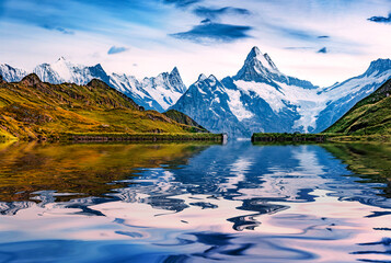 Wetterhorn peak reflected in the calm waters of Bachalpsee lake. Stunning autumn view of Swiss...