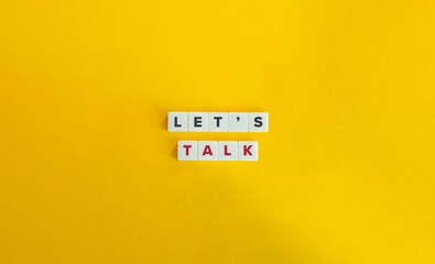 Let’s Talk Phrase. Text on Block Letter Tiles on Yellow Background. Minimalist Aesthetics.