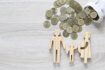 Model family and stack of coins money on wooden background,Save money for prepare in future and...