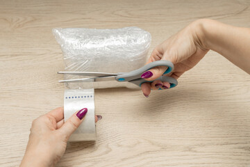 woman packing a parcel on the table
