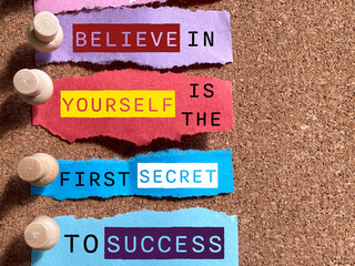 Believe in yourself is the first secret to success text on torn paper background. Stock photo.