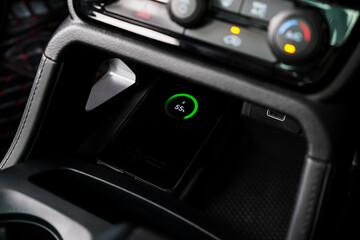 Wireless mobile charger in the modern car. Portable wireless car charger for smartphone.	