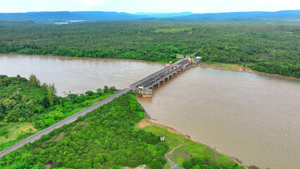Majestic dam stands sentinel, its massive floodgates poised against the churning river's fury. A...