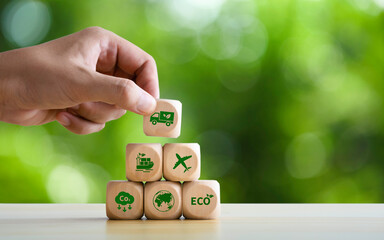 Green logistics or Sustainable transport icon on Wooden block Business sustainable strategy for global shipment or cargo shipping. transportation with clean energy process to Net zero carbon emission.