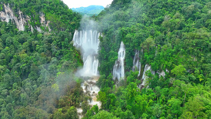 Aerial perspective unveils a breathtaking spectacle - a magnificent waterfall concealed within the...
