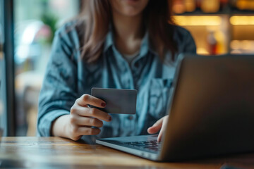The girl holds a bank card in front of her. she makes a purchase online or checks her financial transactions. This image emphasizes the concept of financial responsibility and autonomy in managing you
