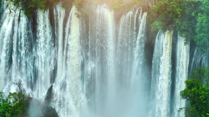 A hidden gem in the heart of a lush tropical rainforest, a colossal waterfall cascades through...
