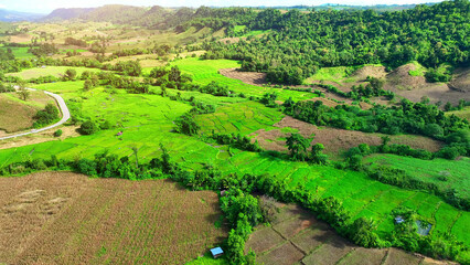 Aerial views from drones unveil the rich tapestry of crops and settlements on hill and plateau...