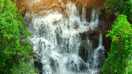 Discover a hidden gem in the heart of a lush tropical rainforest. A waterfall, its cascading layers...