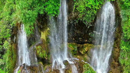Jungle gem: Discover the enchanting allure of a triple waterfall concealed within the depths of a...