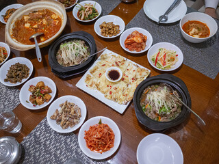 many kinds of plates of korean foods on the table in capital amman