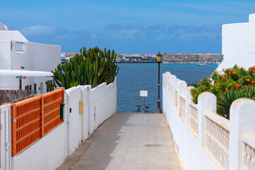 White architecture in village on the ocean shore, Corralejo, Fuerteventura Canary islands. Way to...