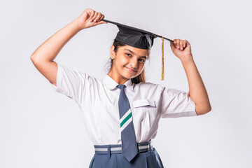 Indian asian cute little school girl wesra graduation white against white background