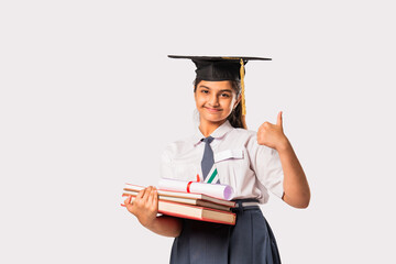 Indian asian cute little school girl wesra graduation white against white background