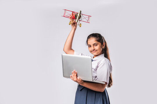 Indian asian cute little school kid studying aeroplane with a model plane - Powered by Adobe