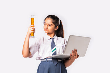 Cute little Indian asian schoolgirl studying chemistry with chemical in glass flask and laptop