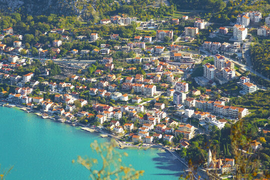 Real estate on the sea coast: aerial view of the development in Dobrota, a suburb of the city of Kotor. Houses in Montenegro.
